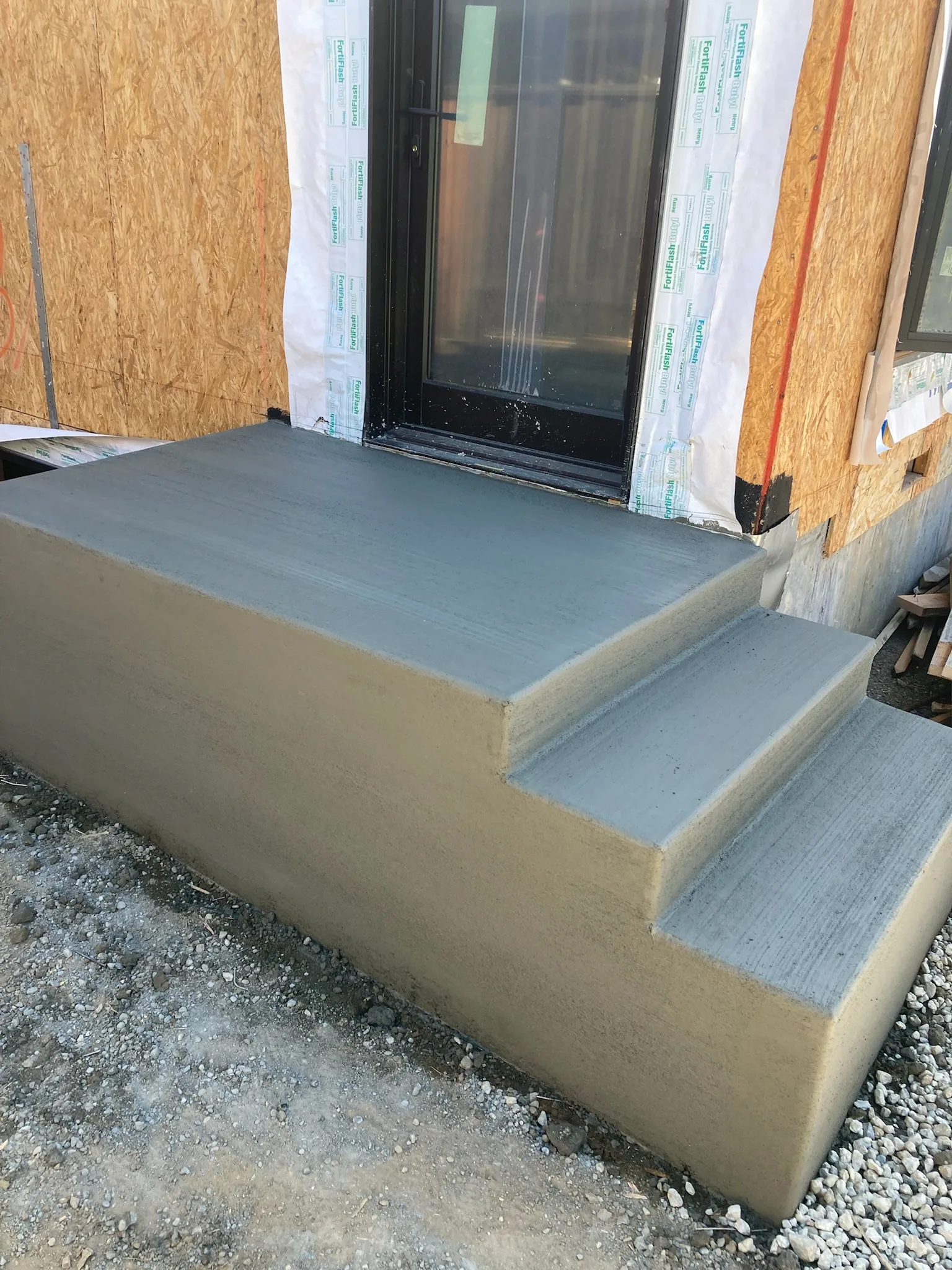Fresh concrete entry steps and landing